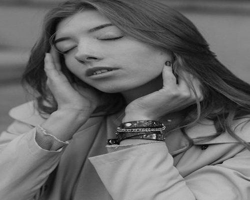 Close up of a person meditating in a peaceful home environment